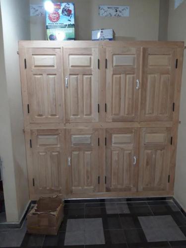 a large wooden cabinet in the corner of a room at Nedunkerniy Sri Lanka 