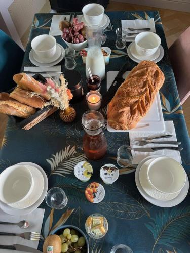 a table with bread and other food on it at Maison Menadel in Yvetot