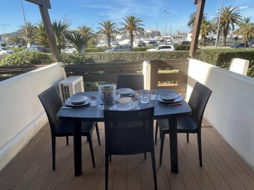 une table bleue et des chaises sur un balcon dans l'établissement Studio cabine rénové climatisé, 2 couchages, plage à proximité - Cap d'Agde Naturisme - FR-1-249A-32, au Cap d'Agde