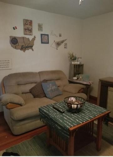 a living room with a couch and a table at Travelers Guesthouse in Greenfield