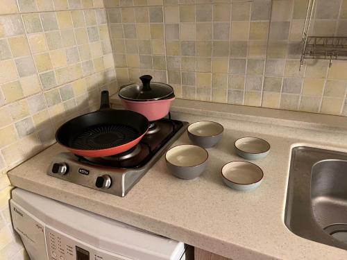 a pot on top of a stove in a kitchen at Jnineguesthouse in Seoul