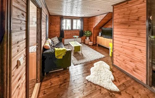 a living room with a couch and a tv at 4 Bedroom Awesome Home In Rysstad in Rysstad