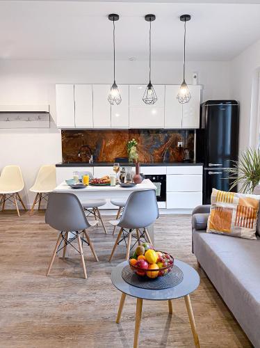 a kitchen and living room with a table and chairs at 31-Vezuvio - DeerRest Apart in Jelenia Góra
