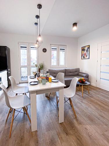 a living room with a table and chairs and a couch at 31-Vezuvio - DeerRest Apart in Jelenia Góra