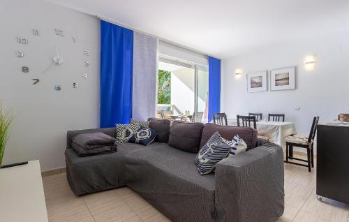 a living room with a couch and a clock on the wall at Beautiful Apartment In El Vergel in Denia