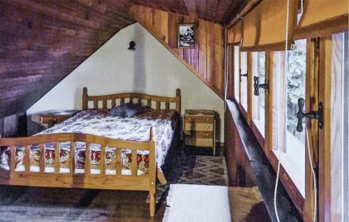 a bedroom with a bed in a log cabin at 1 Bedroom Amazing Home In Policko 