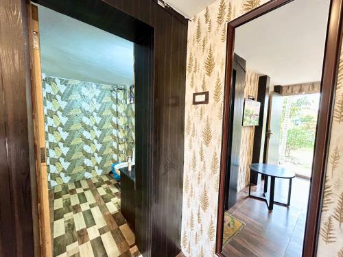 a hallway with a mirror and a table in a room at Palli Bangla Resort, near Ruby Hospital, Anandapur in Kolkata