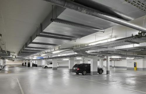 a parking garage with two cars parked in it at TITANIC Chaussee Berlin in Berlin