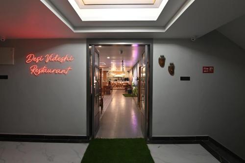 a hallway leading to a store with a green carpet at KP Hotels in Begusarai