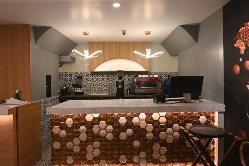a kitchen with a counter with a counter top at KP Hotels in Begusarai