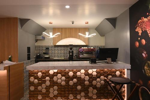 a kitchen with a counter with a stove top oven at KP Hotels in Begusarai