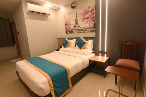 a small bedroom with a bed and a chair at KP Hotels in Begusarai