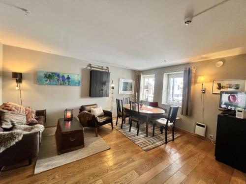 a living room with a couch and a table at Cosy Apartement close to Geilo in Geilo