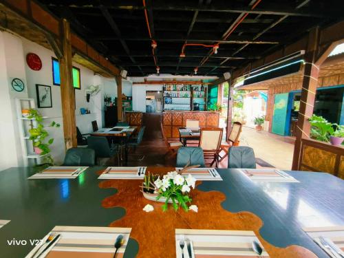 a dining room with a large table and chairs at Rene's Diverslounge Resort in Calape