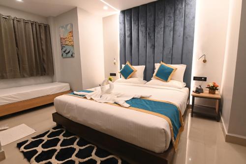 a bedroom with a large bed with a stuffed animal on it at KP Hotels in Begusarai