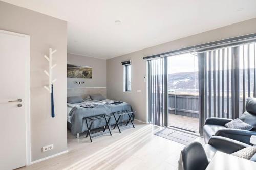 a bedroom with a bed and a balcony at Laxárdalur Cabin in Einarsstaðir