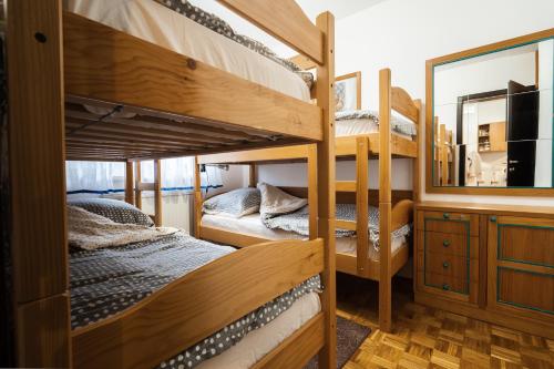 a room with two bunk beds and a mirror at Apartment Maj, Kranjska Gora in Kranjska Gora