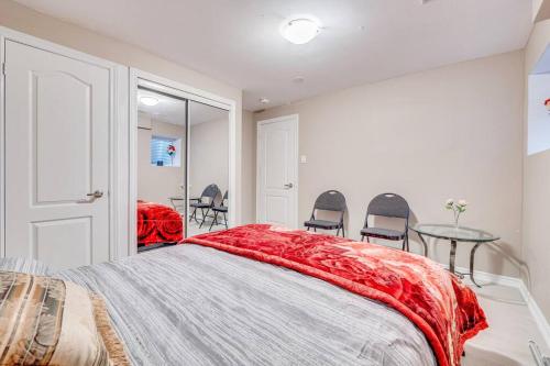 a bedroom with a bed and a table and chairs at Hidden Gem: Spacious Basement in Milton