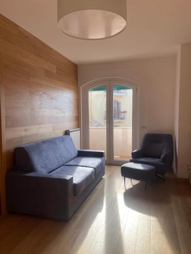 a living room with a blue couch and a chair at Villa Rosanna - Castel di Sangro in Castel di Sangro