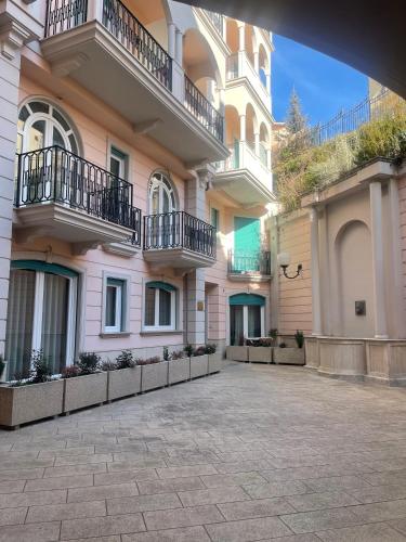 a large pink building with balconies and a courtyard at Villa Rosanna - Castel di Sangro in Castel di Sangro