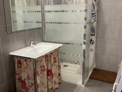 a bathroom with a sink and a shower at Séjour au Bord de l’eau - Moulin Authentique avec Pêche et Confort Moderne - FR-1-410-393 in Mézières-sur-Ponthouin