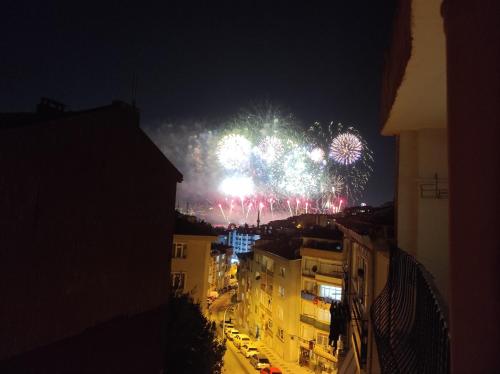 a firework display in the sky over a city at night at USKUDAR Home in Istanbul
