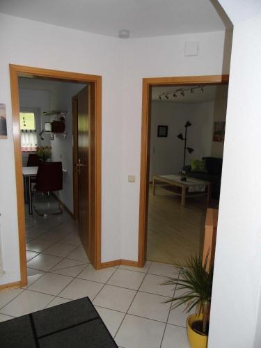 a living room with a door open to a living room at Ferienwohnung Hof 22 in Hilchenbach