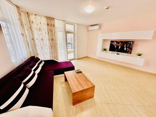 a living room with a couch and a coffee table at Charming 2-bed flat with pool view in Sunny Beach, Bulgaria in Sunny Beach