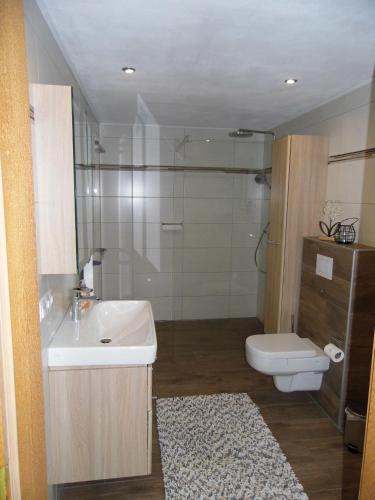 a bathroom with a sink and a toilet at Ferienwohnung Hof 22 in Hilchenbach