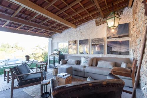 a living room with a couch and chairs at Casal da serra da Arrábida in Palmela