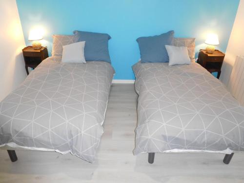 two beds sitting next to each other in a room at Charmant Gîte Familial à Gilley, Proche Fayl-Billot et Cite Fortifiée de Langres - FR-1-611-71 in Gilley