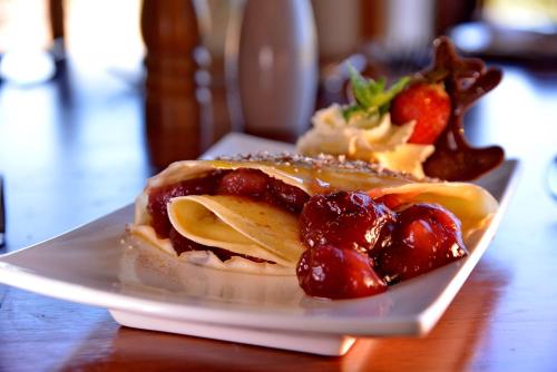 a plate of food with a dessert on a table at Pumula Beach Hotel in Umzumbe