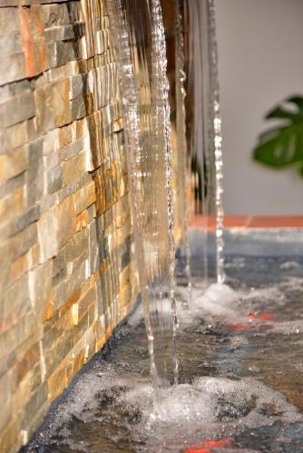 a water fountain coming out of the side of a building at Pumula Beach Hotel in Umzumbe