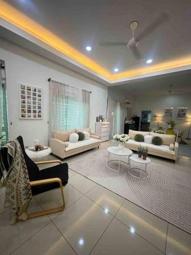 a large living room with couches and tables at Homestay taiping in Taiping