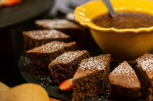 a plate of brownies and a bowl of chocolate at Max Savassi Apart Service in Belo Horizonte