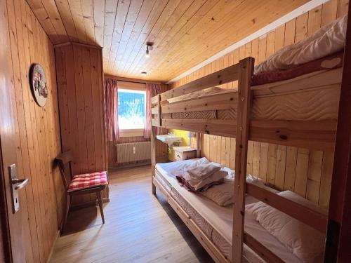 a room with two bunk beds in a cabin at ZE Mountain Lodge, Morgins in Morgins