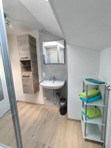 a bathroom with a sink and a mirror at Ferienhaus Brütting in Pottenstein