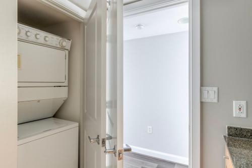 a kitchen with a white refrigerator and a window at Blueground Bethesda gym nr dining shopping WDC-856 in Bethesda