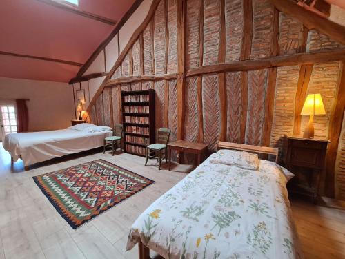 a bedroom with a bed in a room with wooden walls at Gîte Bellegarde, 4 pièces, 6 personnes - FR-1-590-2 in Bellegarde-du-Loiret