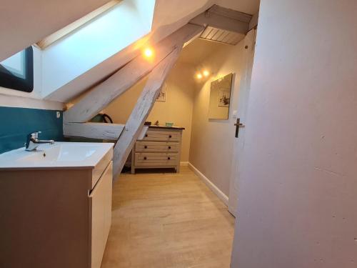 an attic kitchen with a sink and a dresser at Gîte familial près de l'étang des Bois avec cheminée et véranda chauffée - FR-1-590-89 in Vieilles-Maisons-sur-Joudry
