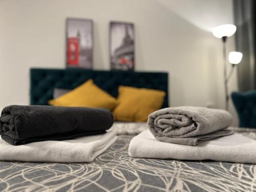 two towels sitting on top of a bed at Apartman ROYAL Bulevar in Zenica