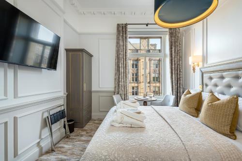 a bedroom with a large bed and a window at RÌGH Residences - George Street in Edinburgh