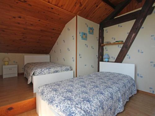 two beds in a room with wooden ceilings at Gîte Champdray, 3 pièces, 4 personnes - FR-1-589-64 in Champdray