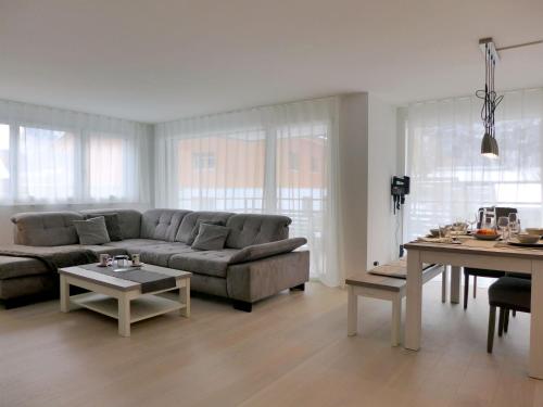 a living room with a couch and a table at Apartment Feldli by Interhome in Meiringen