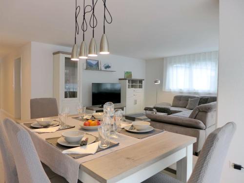 a dining room and living room with a table and chairs at Apartment Feldli by Interhome in Meiringen