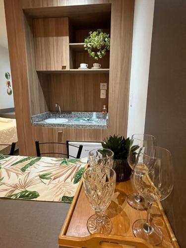 a table with wine glasses on top of it at Apart-hotel Nova Friburgo Com café da manhã in Nova Friburgo