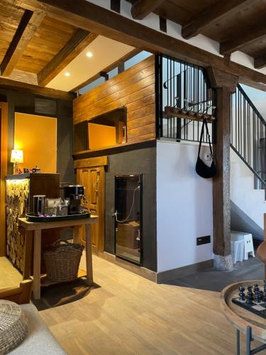 a large kitchen with wooden walls and wooden floors at La Casa del Cantero in Pinilla del Valle