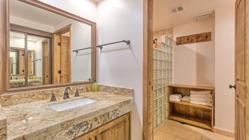 a bathroom with a sink and a mirror at Right on the Beach! 1 Bedroom Ground Floor Ocean Front in Puerto Peñasco