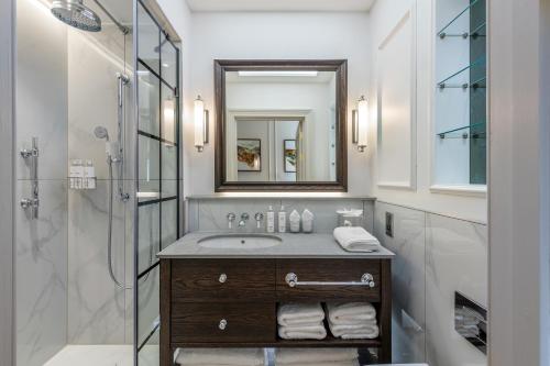 a bathroom with a sink and a shower at RÌGH Residences - George Street in Edinburgh
