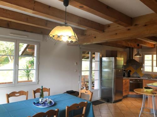 Il comprend une cuisine équipée d'une table bleue et d'un réfrigérateur. dans l'établissement Chalet spacieux avec balcon, WiFi gratuit, proche lac et station de ski - FR-1-589-140, à Gérardmer